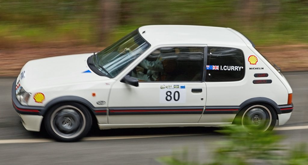 FRENCH FLYER: Iain Curry's classic Peugeot 205 GTi on a charge at the 2015 Mid Year Noosa Hill Climb. He looks faster than he really is. Photo: Tony MacKenzie FRENCH FLYER: Iain Curry's classic Peugeot 205 GTi on a charge at the 2015 Mid Year Noosa Hill Climb. He looks faster than he really is. Photo: Tony MacKenzie