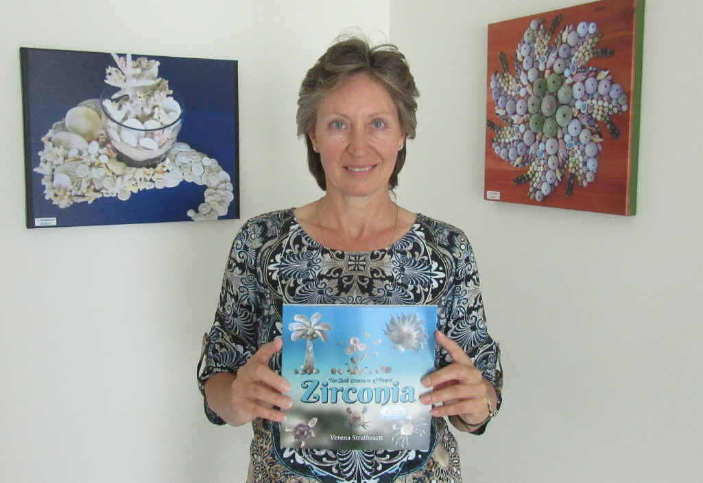 TURN THE PAGE: Verena Strathearn holds a copy of her book: The Shell Creatures of Planet Zirconia.