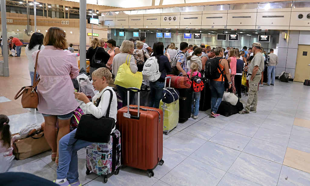 DELAYS: Russian tourists depart from Sharm el-Sheikh airport in Egypt, while (INSET) people in St Petersburg pay tribute to the 224 people who died on the Russian plane that crashed last weekend. DELAYS: Russian tourists depart from Sharm el-Sheikh airport in Egypt, while (INSET) people in St Petersburg pay tribute to the 224 people who died on the Russian plane that crashed last weekend.