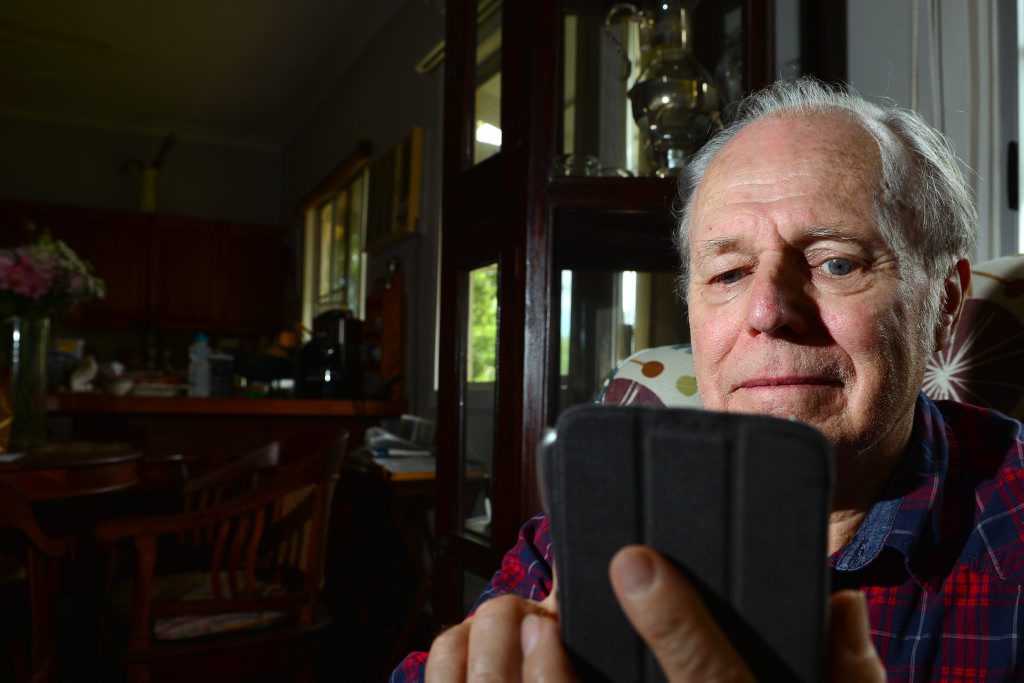 SHINING LIGHT: John Ennis spends long nights on the phone counselling desperate detainees on Manus Island. SHINING LIGHT: John Ennis spends long nights on the phone counselling desperate detainees on Manus Island.
