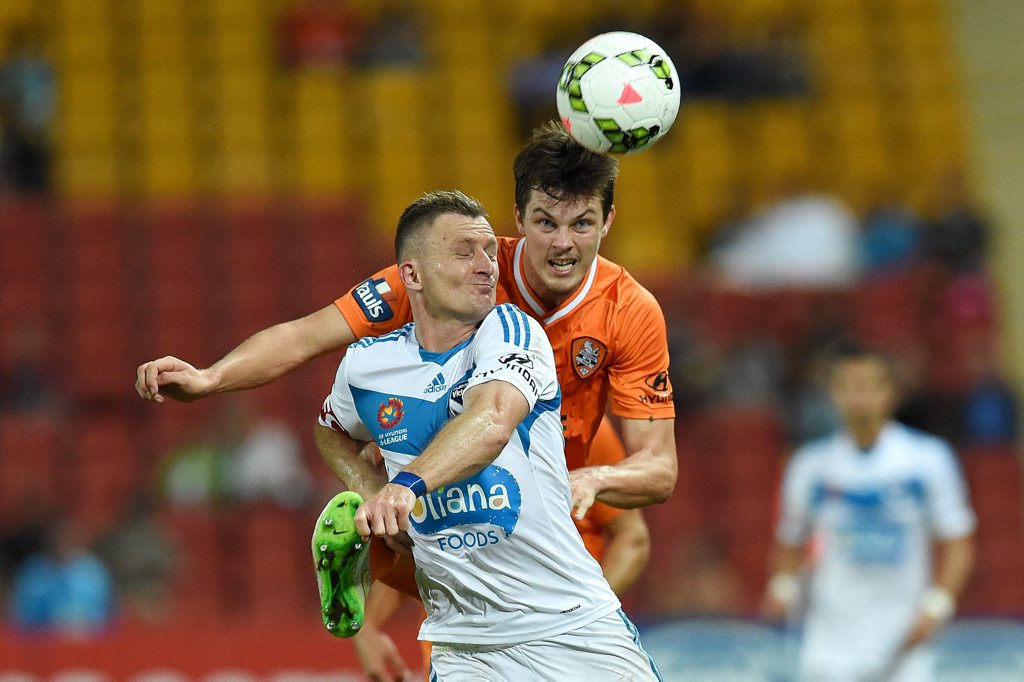 Brisbane Roar 's James Donachie kicks past Melbourne Victory's Besart Berisha in an A-League match last April. Photo: AAP Image/Dan Peled. Brisbane Roar 's James Donachie kicks past Melbourne Victory's Besart Berisha in an A-League match last April. Photo: AAP Image/Dan Peled.