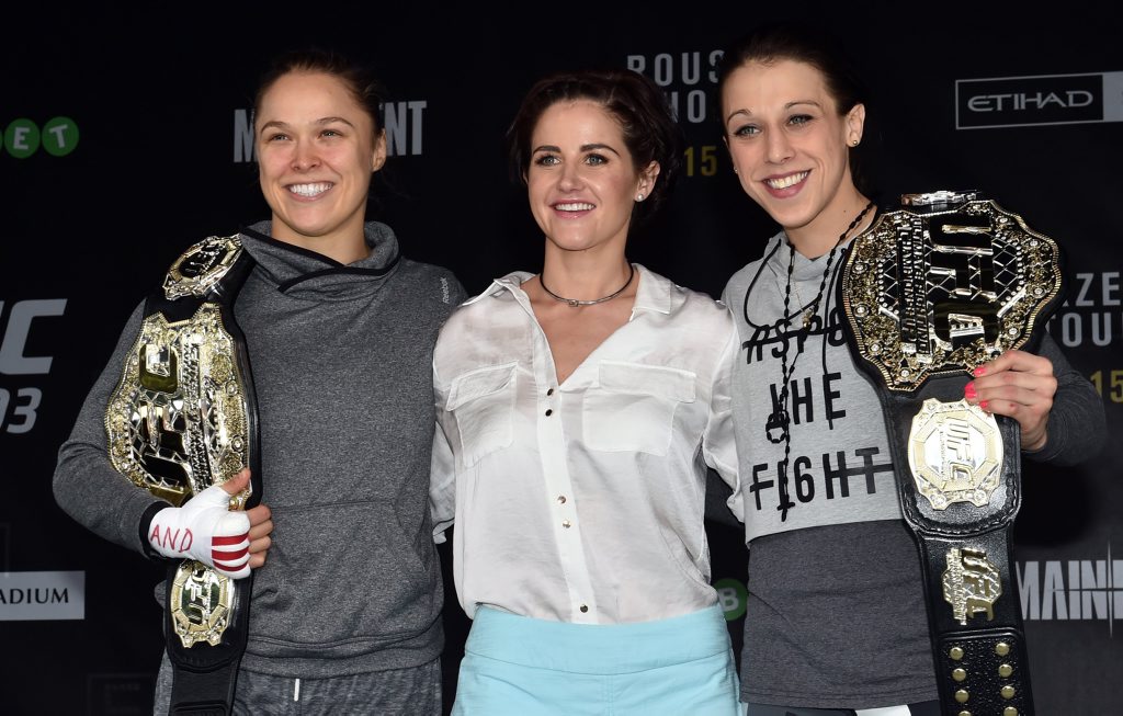 (L-R) UFC fighters Ronda Rousey (left) and Joanna Jedrzejczyk (right) pose for photos with Melbourne Cup winning jockey Michelle Payne on stage at Federation Square in Melbourne. Photo: AAP Image/Julian Smith. (L-R) UFC fighters Ronda Rousey (left) and Joanna Jedrzejczyk (right) pose for photos with Melbourne Cup winning jockey Michelle Payne on stage at Federation Square in Melbourne. Photo: AAP Image/Julian Smith.