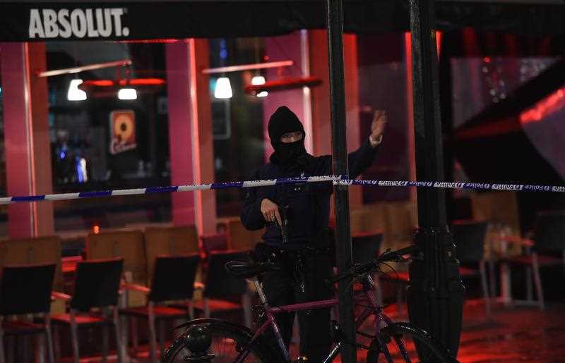 A Belgian police officer gestures behind a cordon as a reported police intervention takes place around the Grand Place central square in Brussels on November 22, 2015. Brussels will remain at the highest possible alert level with schools and metros closed over a A Belgian police officer gestures behind a cordon as a reported police intervention takes place around the Grand Place central square in Brussels on November 22, 2015. Brussels will remain at the highest possible alert level with schools and metros closed over a