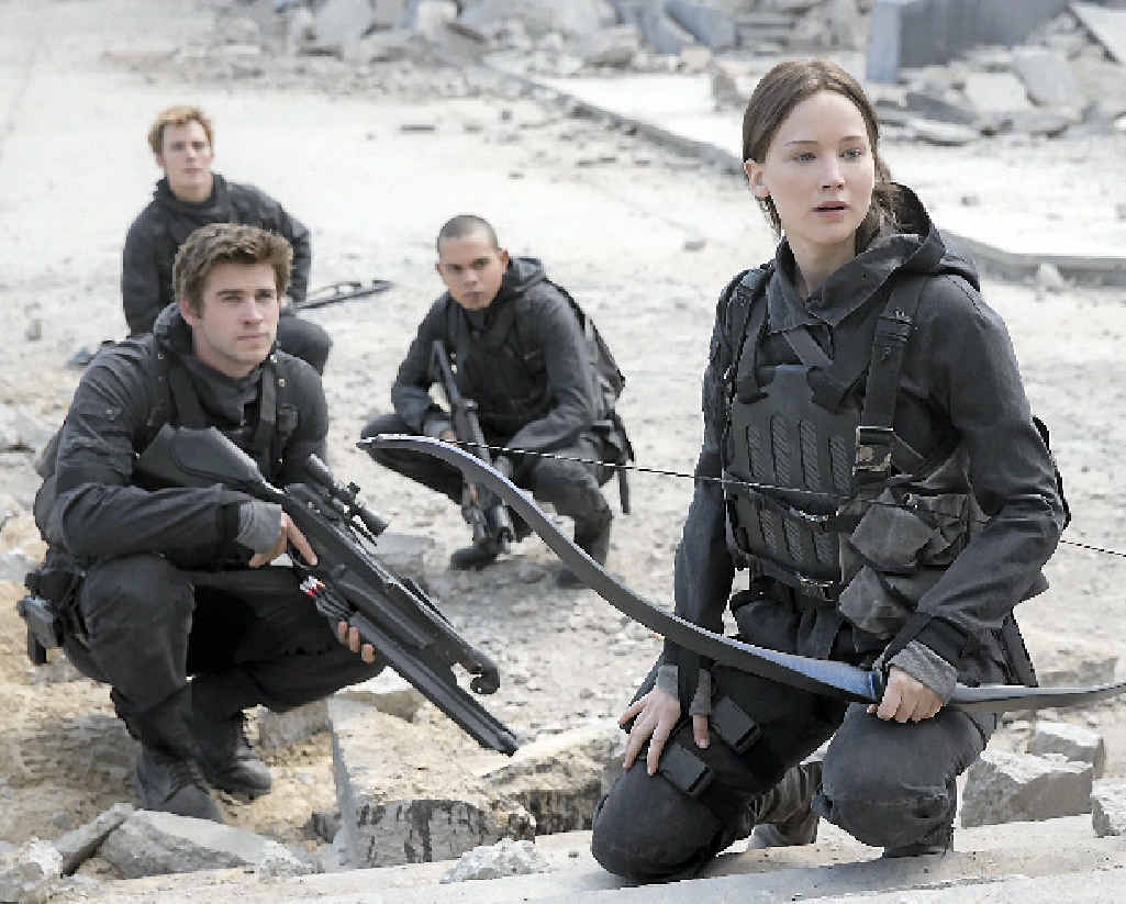 XXXX: From left, Sam Claflin, Liam Hemsworth and Jennifer Lawrence in a scene from the movie The Hunger Games: Mockingjay - Part 2. XXXX: From left, Sam Claflin, Liam Hemsworth and Jennifer Lawrence in a scene from the movie The Hunger Games: Mockingjay - Part 2.
