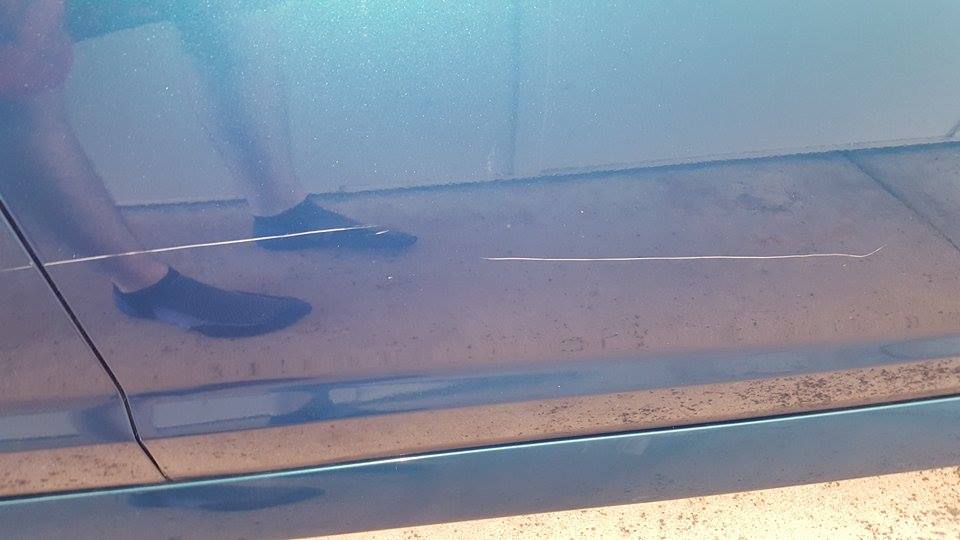 A photo of damage done to a new car by the young children. A photo of damage done to a new car by the young children.