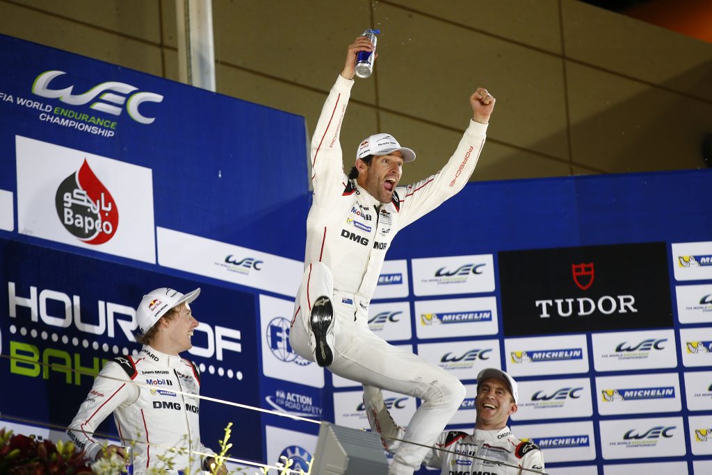 WINNING FEELING: Mark Webber celebrates becoming World Endurance Champion for 2015 alongside team-mates Brendon Hartley and Timo Bernhard after a fifth place at the 6 Hours of Bahrain. WINNING FEELING: Mark Webber celebrates becoming World Endurance Champion for 2015 alongside team-mates Brendon Hartley and Timo Bernhard after a fifth place at the 6 Hours of Bahrain.