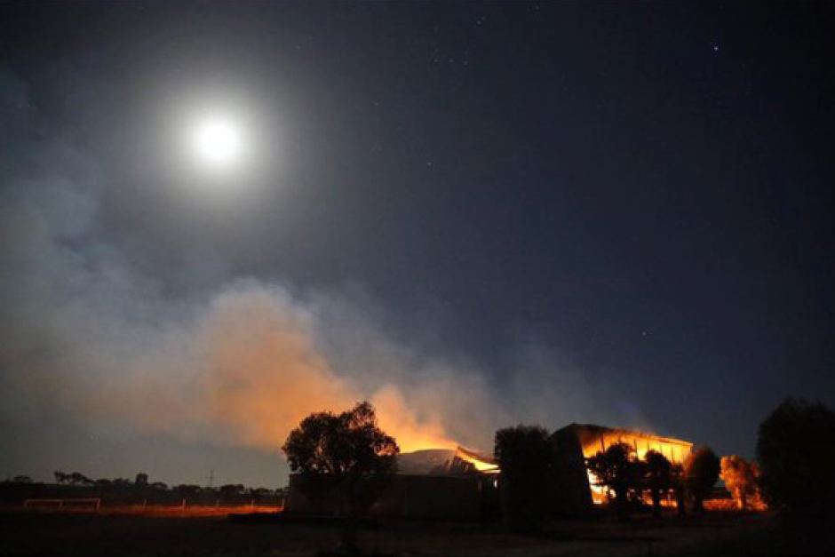 A burning hay shed in moonlight near Roseworthy in South Australia. Photo: Carl Saville A burning hay shed in moonlight near Roseworthy in South Australia. Photo: Carl Saville
