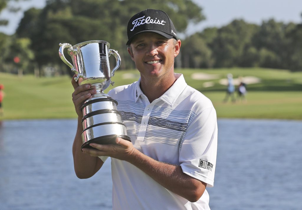 Matthew Jones poses for photographers as he holds the Stone Haven Cup after winning the Australian Open golf tournament in Sydney. Photo: AP Photo/Rob Griffith. Matthew Jones poses for photographers as he holds the Stone Haven Cup after winning the Australian Open golf tournament in Sydney. Photo: AP Photo/Rob Griffith.