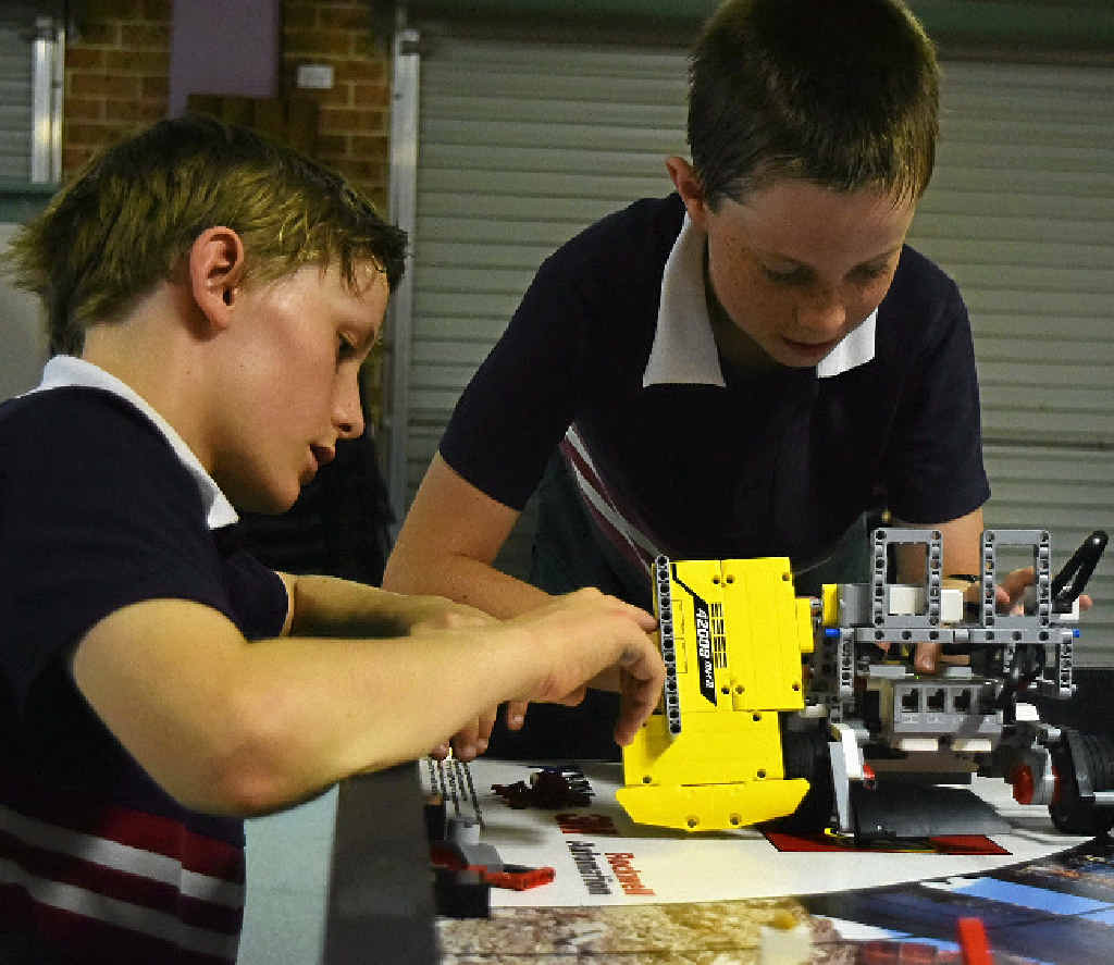 NEW EXPERIENCE: Skennars Head students Reuben Adlington, 11, and Ben Masterson, 10, are programming robots to clean up waste and debris. NEW EXPERIENCE: Skennars Head students Reuben Adlington, 11, and Ben Masterson, 10, are programming robots to clean up waste and debris.