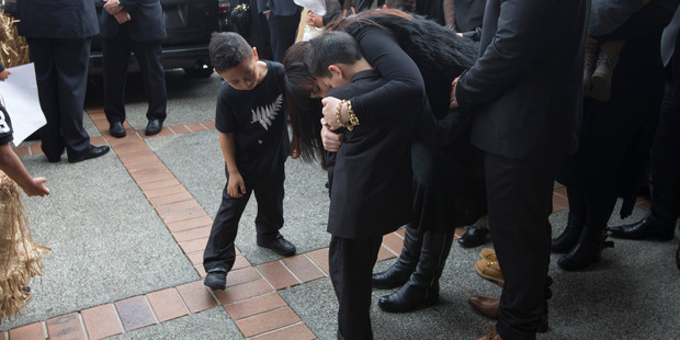 Nadene Lomu holds her boys close as family and friends gather to farewell Jonah Lomu. Photo / Brett Phibbs Nadene Lomu holds her boys close as family and friends gather to farewell Jonah Lomu. Photo / Brett Phibbs