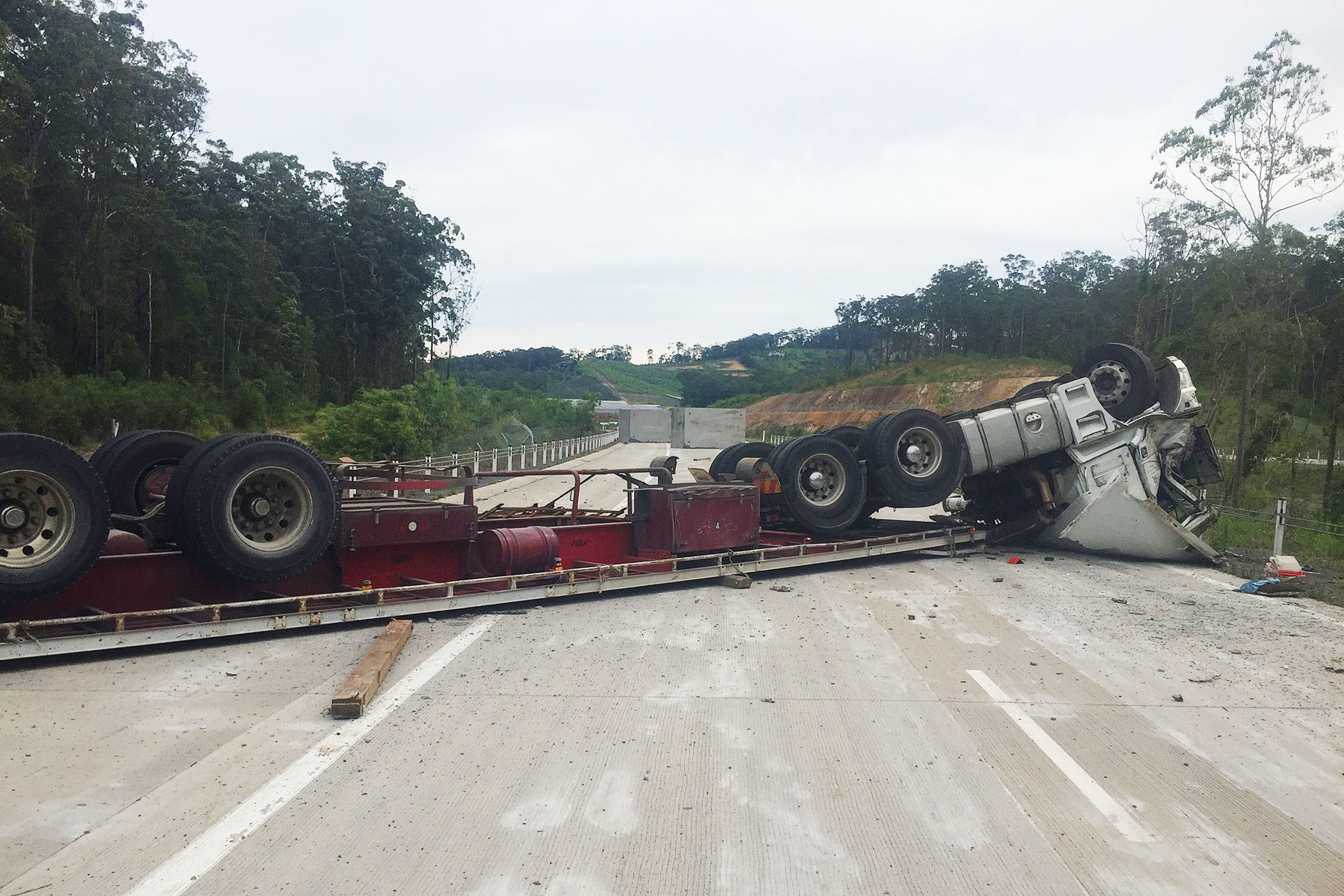 A semi-trailer rollover has blocked both southbound lanes of the pacific hwy near Woolgoolga. A semi-trailer rollover has blocked both southbound lanes of the pacific hwy near Woolgoolga.