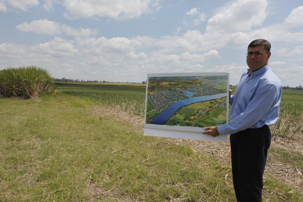 Maryborough Sugar CEO Mike Barry with an artist's impression of the company's proposed $500 million Mary Harbour project at Granville on land that is now under sugar cane. Photo: JOCELYN WATTS 10m949 Maryborough Sugar CEO Mike Barry with an artist's impression of the company's proposed $500 million Mary Harbour project at Granville on land that is now under sugar cane. Photo: JOCELYN WATTS 10m949
