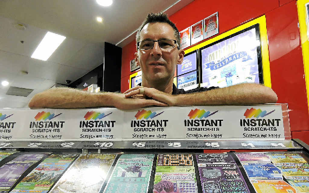NewsXpress Maryborough manager Jason Greer celebrates as two loyal customers bought a winning ticket in his store. NewsXpress Maryborough manager Jason Greer celebrates as two loyal customers bought a winning ticket in his store.