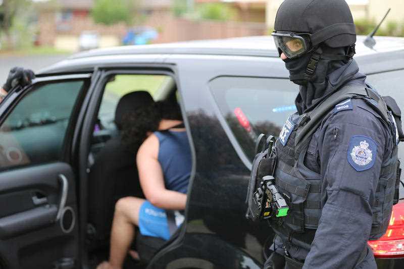 A supplied image obtained Thursday, Dec. 10, 2015 of Australian Federal Police (AFP) officers during an operation at Raby in south-west Sydney. A 20-year-old Raby man and a 15-year-old male from Georges Hall were arrested at their homes this morning, and then later charged with conspiracy to conduct an act in preparation for a terrorist act. A supplied image obtained Thursday, Dec. 10, 2015 of Australian Federal Police (AFP) officers during an operation at Raby in south-west Sydney. A 20-year-old Raby man and a 15-year-old male from Georges Hall were arrested at their homes this morning, and then later charged with conspiracy to conduct an act in preparation for a terrorist act.