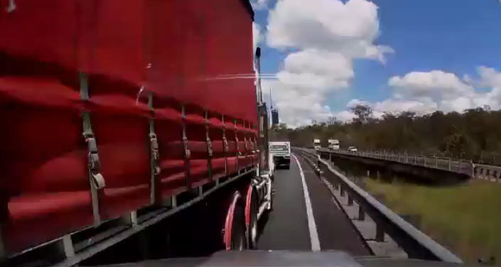 A still image from dash cam footage of a truck sideswiping a Hilux on the Logan Motorway. A still image from dash cam footage of a truck sideswiping a Hilux on the Logan Motorway.