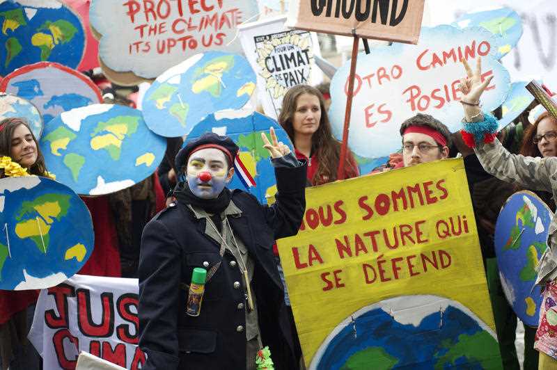A demonstrator disguised as a clown is seen among thousands demanding climate justice and environment protection in Paris on December 12, 2015. A climate march was organized by several NGOs as COP21 negotiations come to an end. A demonstrator disguised as a clown is seen among thousands demanding climate justice and environment protection in Paris on December 12, 2015. A climate march was organized by several NGOs as COP21 negotiations come to an end.