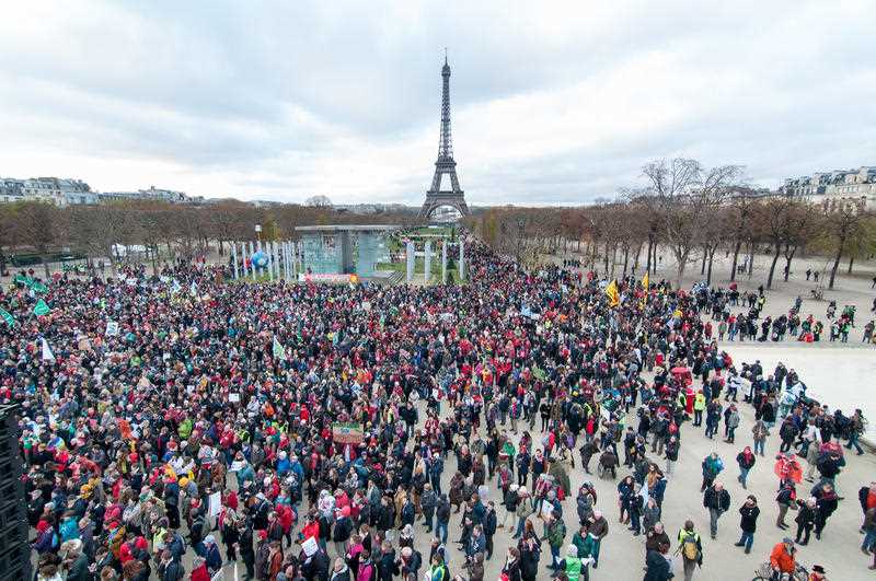 Thousands gather on Paris Champ-de-Mars near the Eiffel tower for a human chain on December 12, 2015. Demonstrators asked for climate justice and environment protection as COP 21 negotiations come to an end. Thousands gather on Paris Champ-de-Mars near the Eiffel tower for a human chain on December 12, 2015. Demonstrators asked for climate justice and environment protection as COP 21 negotiations come to an end.