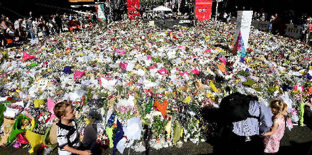 EMOTIONAL OUTPOURING: Sydneysiders lay flowers near the Lindt Cafe in December last year. EMOTIONAL OUTPOURING: Sydneysiders lay flowers near the Lindt Cafe in December last year.