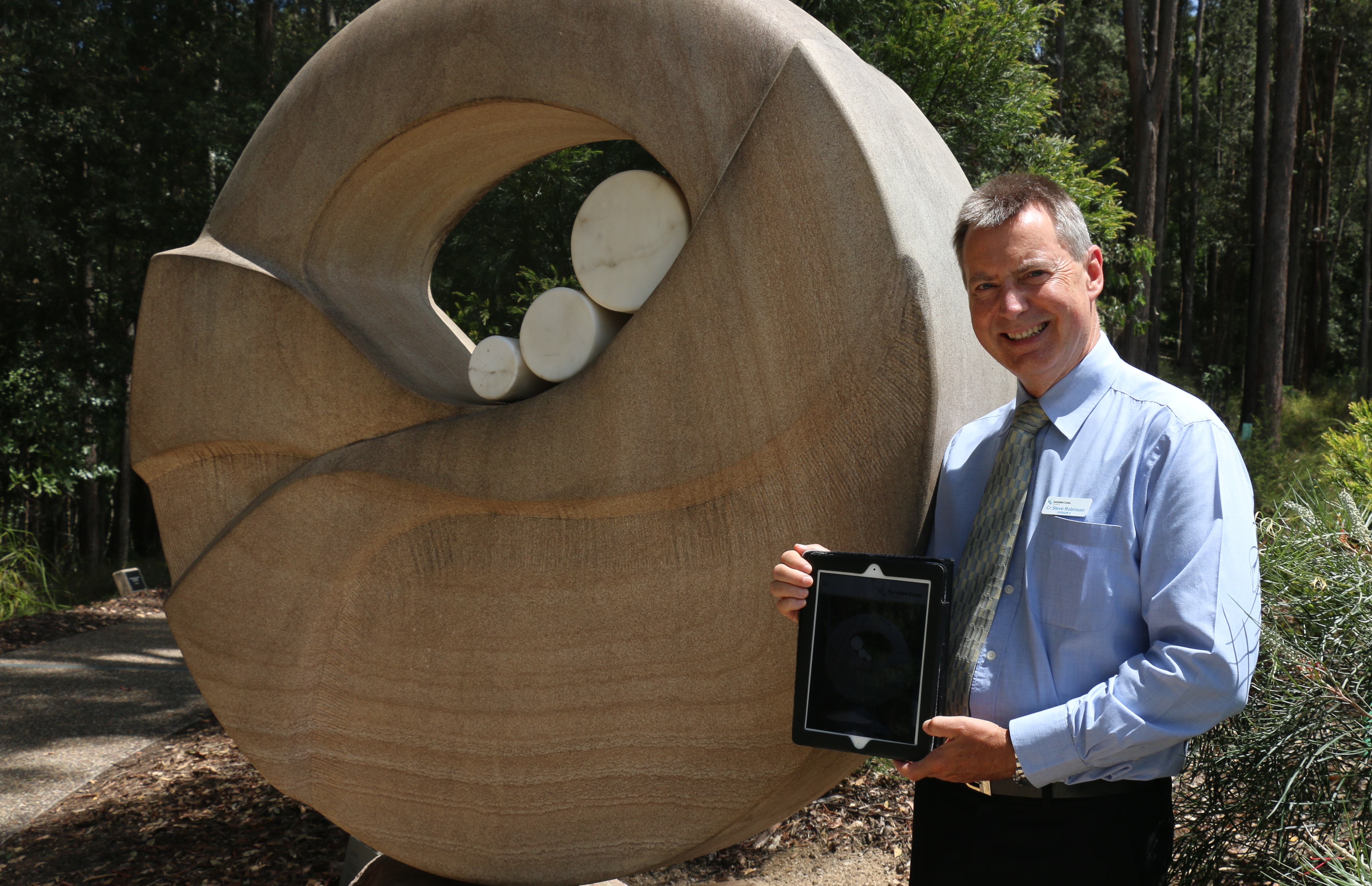 Sunshine Coast Councillor Steve Robinson enjoys a Bluetooth enabled guided walk through the Maroochy Botanical Gardens Sculpture Garden via the SCC app. Sunshine Coast Councillor Steve Robinson enjoys a Bluetooth enabled guided walk through the Maroochy Botanical Gardens Sculpture Garden via the SCC app.