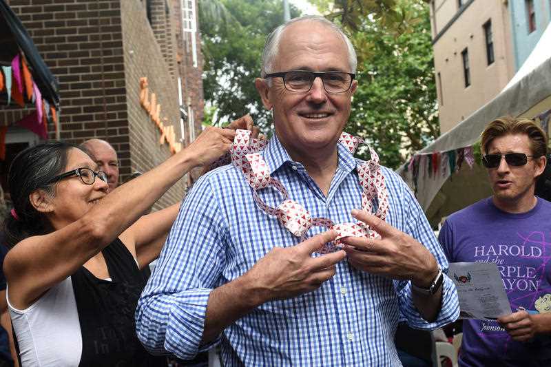 A garland is placed around Australian Prime Minister Malcolm Turnbull, as actor David Wenham (right) looks on at the Wayside Chapel Christmas Day Street Party in Sydney on Friday, Dec. 25, 2015. A garland is placed around Australian Prime Minister Malcolm Turnbull, as actor David Wenham (right) looks on at the Wayside Chapel Christmas Day Street Party in Sydney on Friday, Dec. 25, 2015.