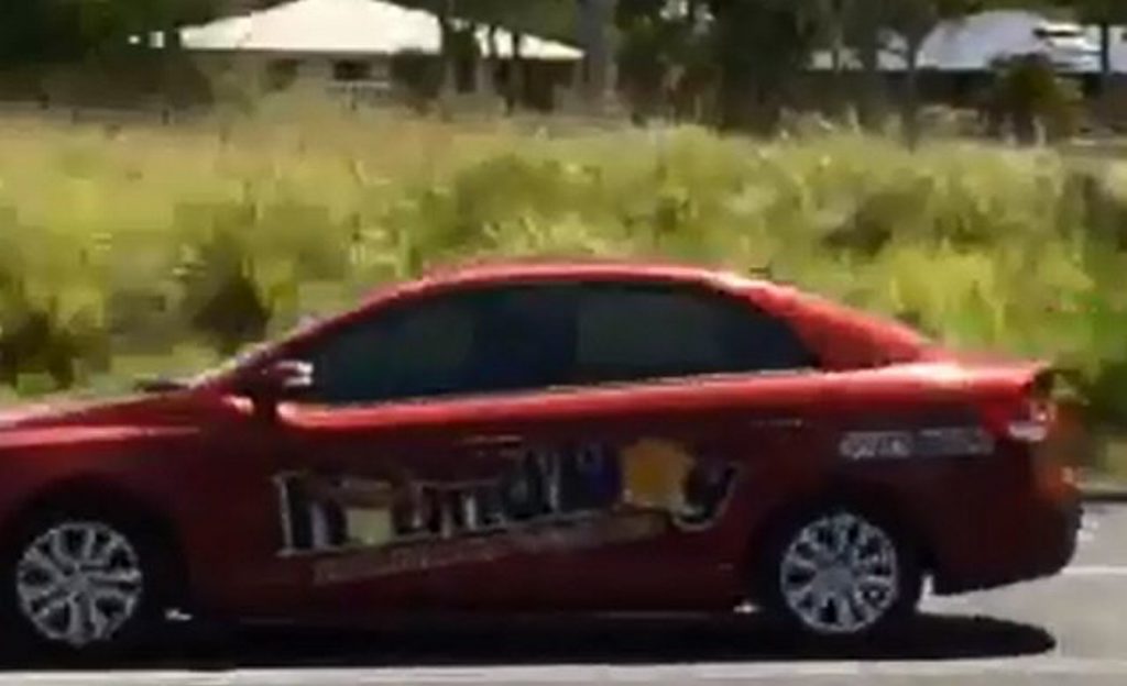 The vehicle three escaped prisoners are driving is described as a red Kia, 821 SWH, registered to a Townsville business. It has signage on both sides of the vehicle The vehicle three escaped prisoners are driving is described as a red Kia, 821 SWH, registered to a Townsville business. It has signage on both sides of the vehicle