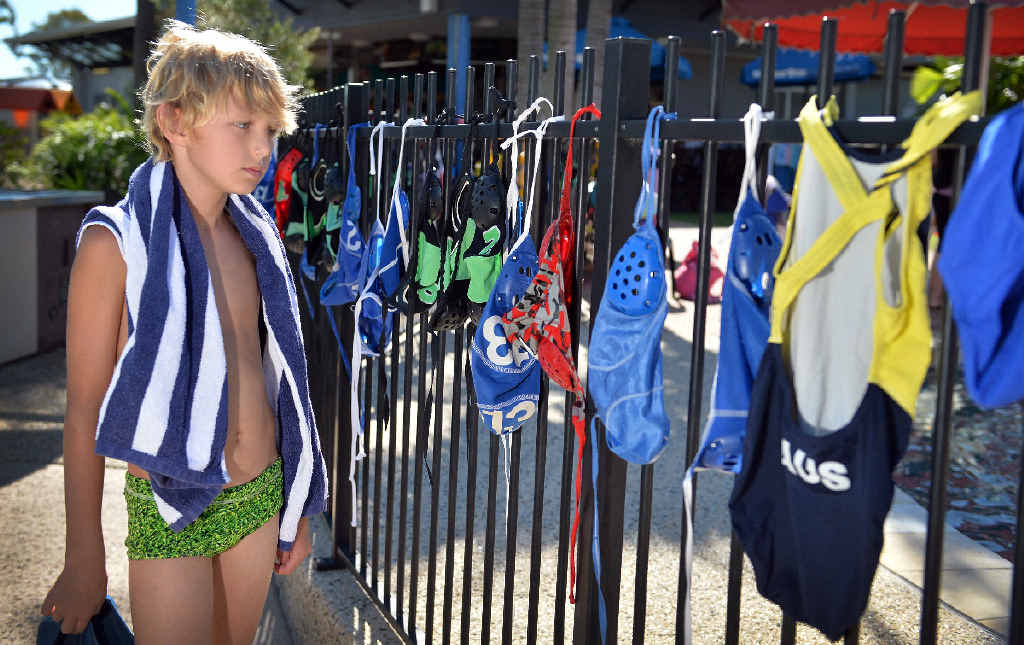Matty Johnston overlooks caps and swimwear, water polo players have hung over the pool fence in memory of Cole Miller at Kawana Aquatic Centre. Matty Johnston overlooks caps and swimwear, water polo players have hung over the pool fence in memory of Cole Miller at Kawana Aquatic Centre.