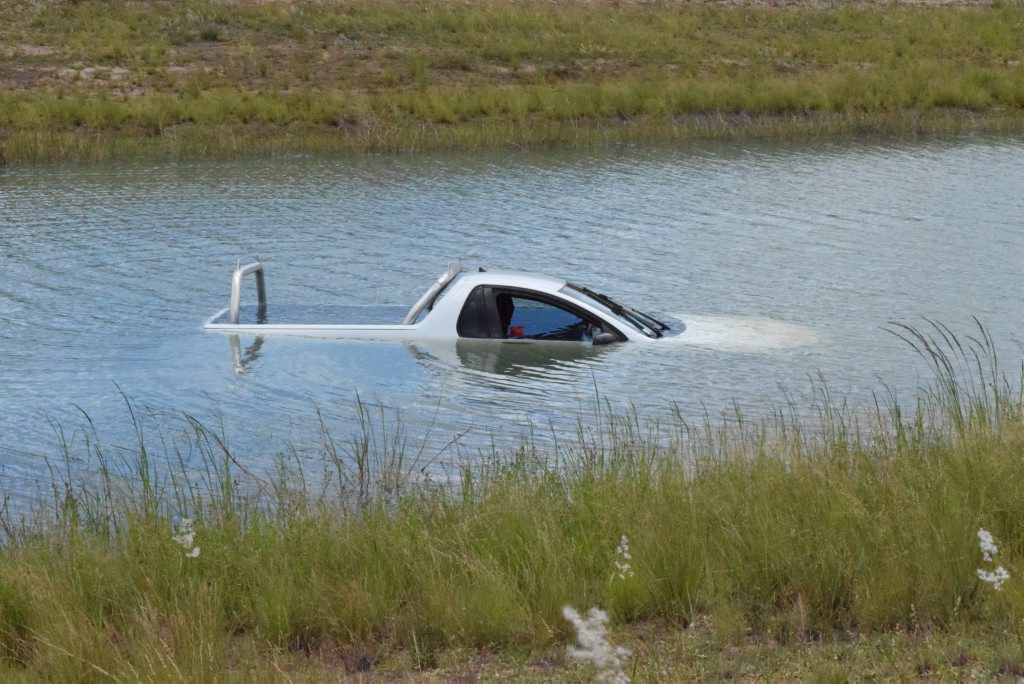 WATERY END: Bundaberg Police are investigating after a white ute was found submerged in an irrigation channel off the Ring Road. Photo Carolyn Archer / NewsMail WATERY END: Bundaberg Police are investigating after a white ute was found submerged in an irrigation channel off the Ring Road. Photo Carolyn Archer / NewsMail