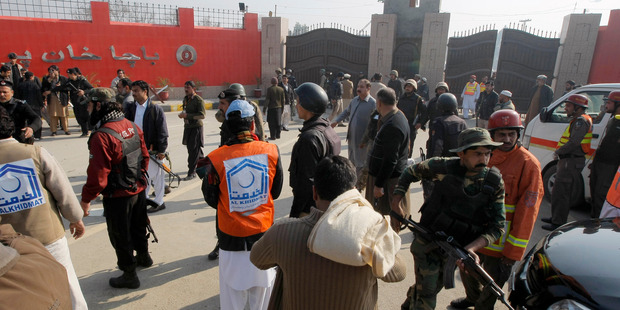 Pakistani troops and rescue workers gather at the main gate of Bacha Khan University Pakistan after gunman attacked killing several people. Photo/Mohammad Sajjad Pakistani troops and rescue workers gather at the main gate of Bacha Khan University Pakistan after gunman attacked killing several people. Photo/Mohammad Sajjad