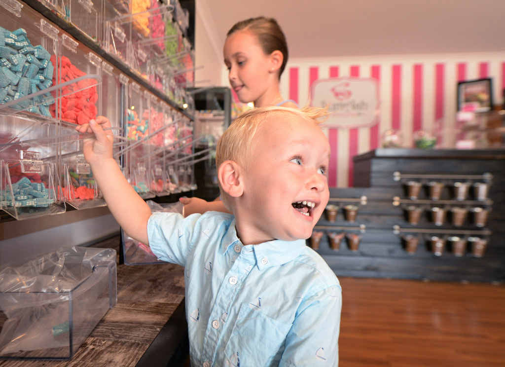 SUGAR RUSH: Two-year-old Fletcher Hare is excited about choosing some lollies at his parent’s new lolly shop on Wandal Rd. INSET: Melissah and Neville Hare have opened SumAsh Sweets. SUGAR RUSH: Two-year-old Fletcher Hare is excited about choosing some lollies at his parent’s new lolly shop on Wandal Rd. INSET: Melissah and Neville Hare have opened SumAsh Sweets.