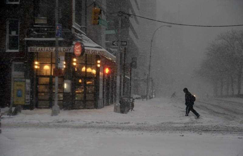 A man walks through the snow on the Lower East Side of Manhattan during a large winter storm in New York, New York, USA, 23 January 2016. Areas of the New York metropolitan region were expected to get up to 2 feet (60 cm) of snow. A man walks through the snow on the Lower East Side of Manhattan during a large winter storm in New York, New York, USA, 23 January 2016. Areas of the New York metropolitan region were expected to get up to 2 feet (60 cm) of snow.