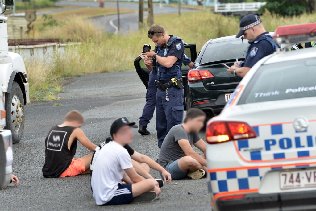 QUICK WORK: Police searched five young men in Tozer St, after intercepting a blue Holden Astra, said to have been seen leaving the fight scene after a Mt Pleasant Australia Day brawl. QUICK WORK: Police searched five young men in Tozer St, after intercepting a blue Holden Astra, said to have been seen leaving the fight scene after a Mt Pleasant Australia Day brawl.
