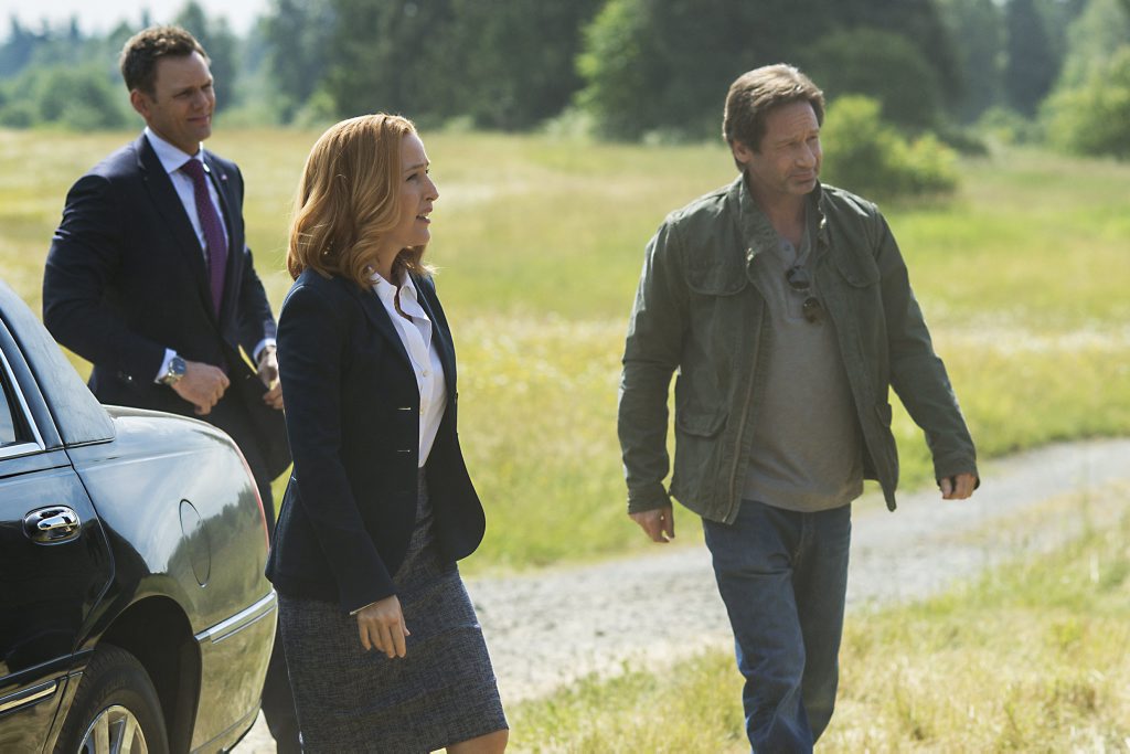 Joel McHale, Gillian Anderson and David Duchovny in a scene from The X-Files. Joel McHale, Gillian Anderson and David Duchovny in a scene from The X-Files.