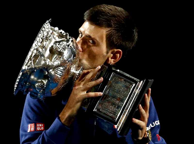 Novak Djokovic of Serbia kisses his trophy after defeating Andy Murray of Britain in the men's singles final at the Australian Open tennis championships in Melbourne, Australia, Sunday, Jan. 31, 2016. Novak Djokovic of Serbia kisses his trophy after defeating Andy Murray of Britain in the men's singles final at the Australian Open tennis championships in Melbourne, Australia, Sunday, Jan. 31, 2016.