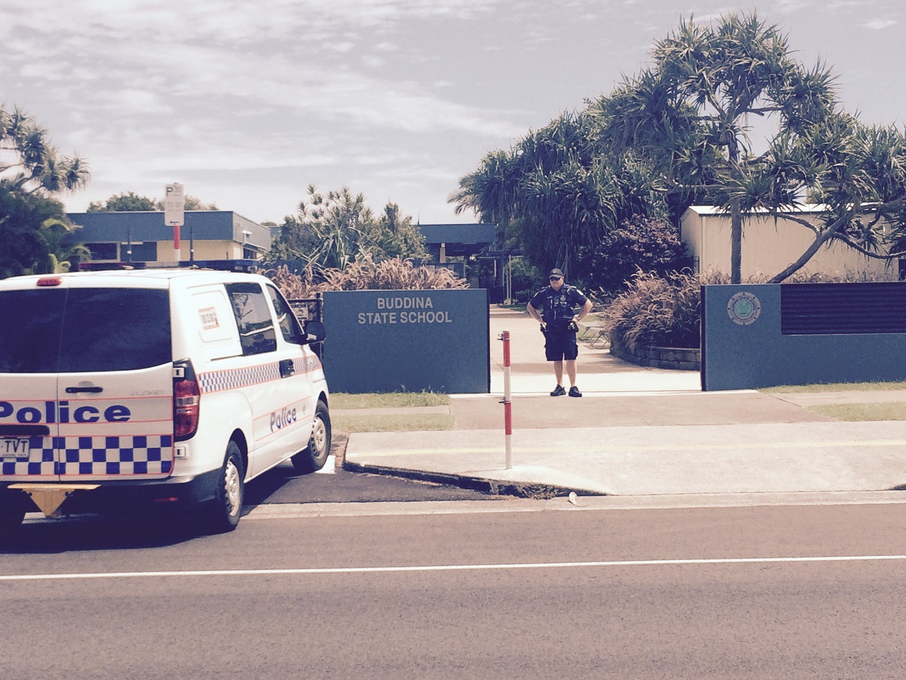 A police officer outside Buddina State School, which has been evacuated after a bomb threat. A police officer outside Buddina State School, which has been evacuated after a bomb threat.