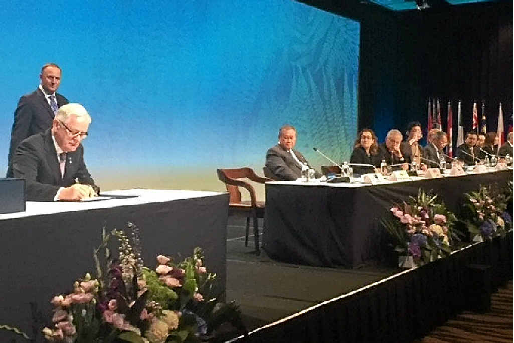 BIG DEAL: Trade Minister Andrew Robb signs the TPP yesterday in Auckland as delegates from other countries look on. BIG DEAL: Trade Minister Andrew Robb signs the TPP yesterday in Auckland as delegates from other countries look on.