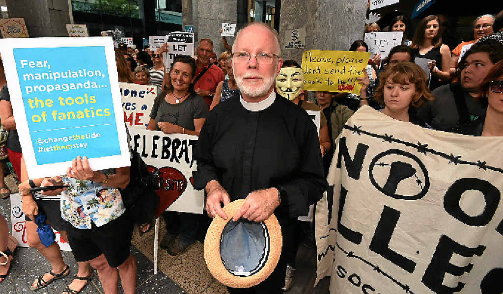 PUSHING FOR CHANGE: Anglican Dean of Brisbane Dr Peter Catt and other pro-refugee protesters rally outside the immigration office in Brisbane yesterday. PUSHING FOR CHANGE: Anglican Dean of Brisbane Dr Peter Catt and other pro-refugee protesters rally outside the immigration office in Brisbane yesterday.