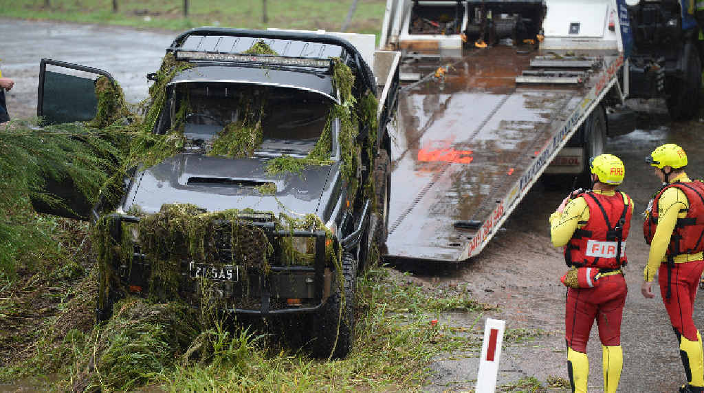TOUGH TASK: A swift water rescue team (including inset) search a stolen LandCruiser ute found in Scrubby Creek. TOUGH TASK: A swift water rescue team (including inset) search a stolen LandCruiser ute found in Scrubby Creek.