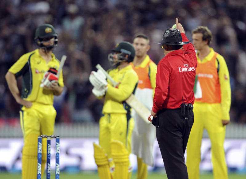 Umpire Ian Gould raises his finger after a video review of a caught and bowled by New Zealand’s Matt Henry of Australia’s Mitchell Marsh, left, in the third One Day International Cricket match at Seddon Park, Hamilton, New Zealand, Monday, Feb. 8, 2016. Umpire Ian Gould raises his finger after a video review of a caught and bowled by New Zealand’s Matt Henry of Australia’s Mitchell Marsh, left, in the third One Day International Cricket match at Seddon Park, Hamilton, New Zealand, Monday, Feb. 8, 2016.