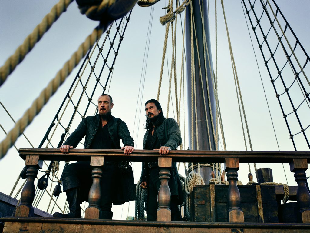 Toby Stephens and Luke Arnold in a scene from season three of Black Sails. Toby Stephens and Luke Arnold in a scene from season three of Black Sails.