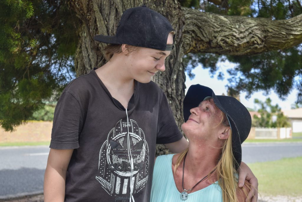 STILL SMILING: Terminally-ill Yamba woman Michelle Baker gets a hug from her 13-year-old son Liam, who has been living with her in tents as they have been unable to find accommodation. STILL SMILING: Terminally-ill Yamba woman Michelle Baker gets a hug from her 13-year-old son Liam, who has been living with her in tents as they have been unable to find accommodation.