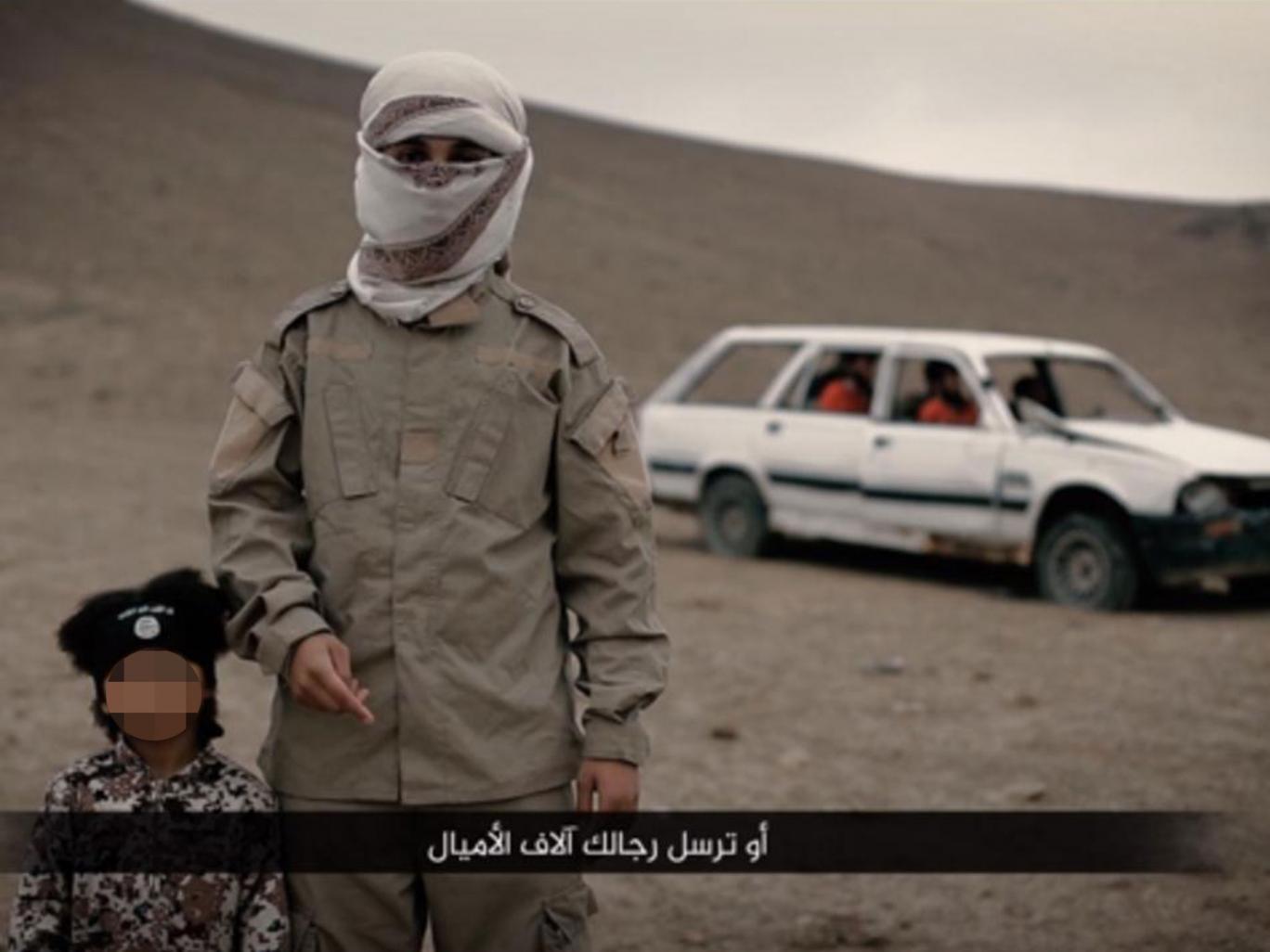 Isa Dare and an unidentified Isis militant believed to be a British teenager in a propaganda video released in February 2016 Isa Dare and an unidentified Isis militant believed to be a British teenager in a propaganda video released in February 2016