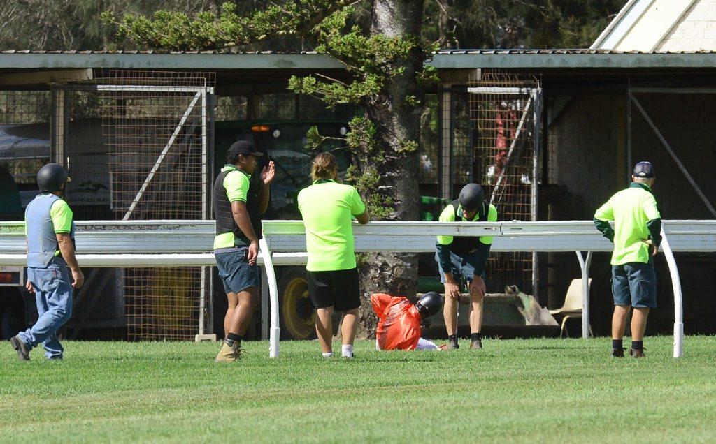 Ipswich Turf Club course crew attend to jockey Robbie Fradd after his race fall. Ipswich Turf Club course crew attend to jockey Robbie Fradd after his race fall.