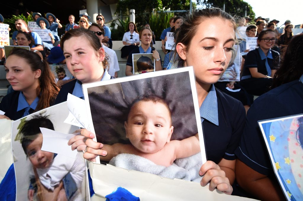 School students hold photos of a baby girl known as Asha during a protest outside the Lady Cilento Children's Hospital in Brisbane on February 18, 2016. The hospital had refused to release Asha, being treated for burns suffered while in detention on Nauru until a School students hold photos of a baby girl known as Asha during a protest outside the Lady Cilento Children's Hospital in Brisbane on February 18, 2016. The hospital had refused to release Asha, being treated for burns suffered while in detention on Nauru until a
