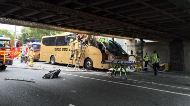 Firefighters and medical staff at the scene where a bus struck a bridge in Melbourne Firefighters and medical staff at the scene where a bus struck a bridge in Melbourne