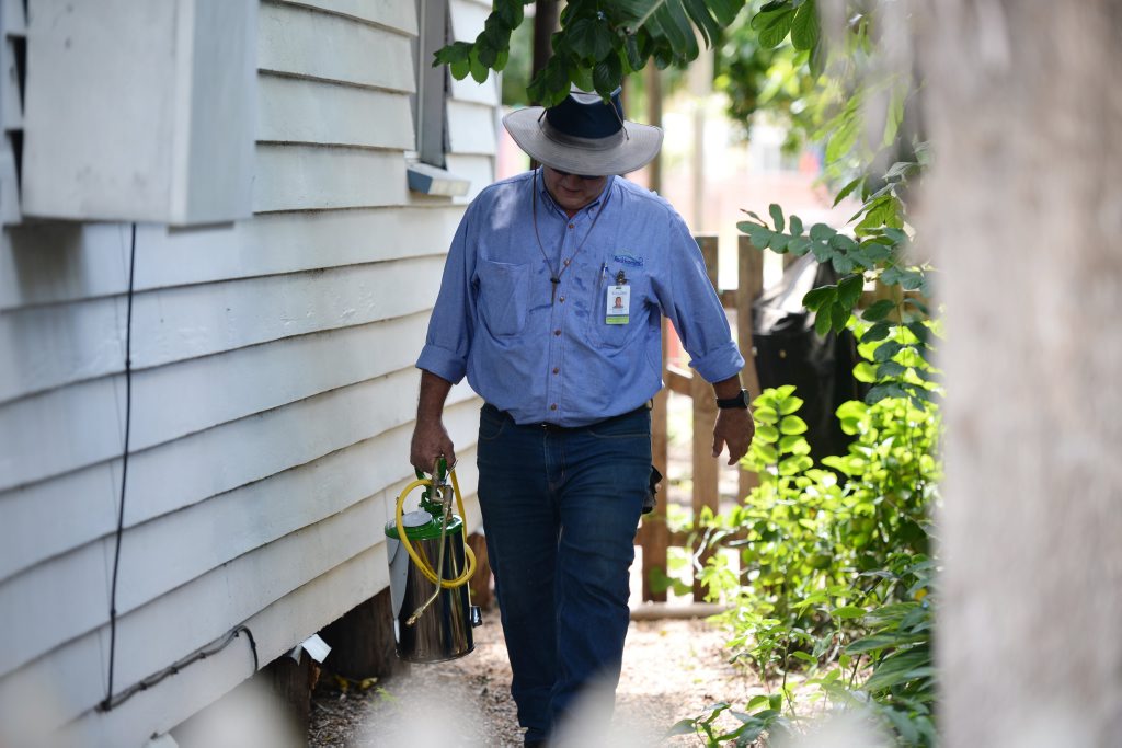 A Queensland Health employee sprays around Russell Burton and Jess Edwards' Depot Hill home to ward off mosquitoes after the Zika virus detected at The Globe Hotel next door. Jess is nine months pregnant. Photo Rachael Conaghan / The Morning Bulletin A Queensland Health employee sprays around Russell Burton and Jess Edwards' Depot Hill home to ward off mosquitoes after the Zika virus detected at The Globe Hotel next door. Jess is nine months pregnant. Photo Rachael Conaghan / The Morning Bulletin
