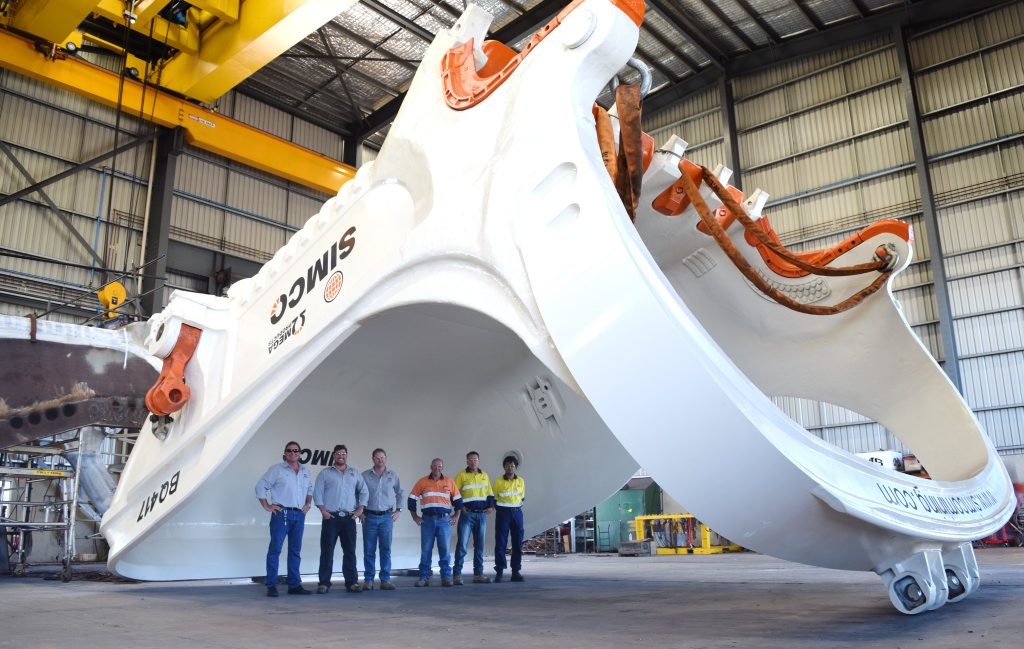 Dwarfed by the huge dragline bucket at the Independent Mining Services Qld workshop at Paget are (from left) IMS director Gary Brown, IMS business development manager Ryan McGovern, IMS operations manager Michael Hilton, SIMCO director Marty Simpson, SIMCO support manager Barry Manning and SIMCO mechanical engineer Sam Hasnat. Photo Alan Quinney / Daily Mercury Dwarfed by the huge dragline bucket at the Independent Mining Services Qld workshop at Paget are (from left) IMS director Gary Brown, IMS business development manager Ryan McGovern, IMS operations manager Michael Hilton, SIMCO director Marty Simpson, SIMCO support manager Barry Manning and SIMCO mechanical engineer Sam Hasnat. Photo Alan Quinney / Daily Mercury