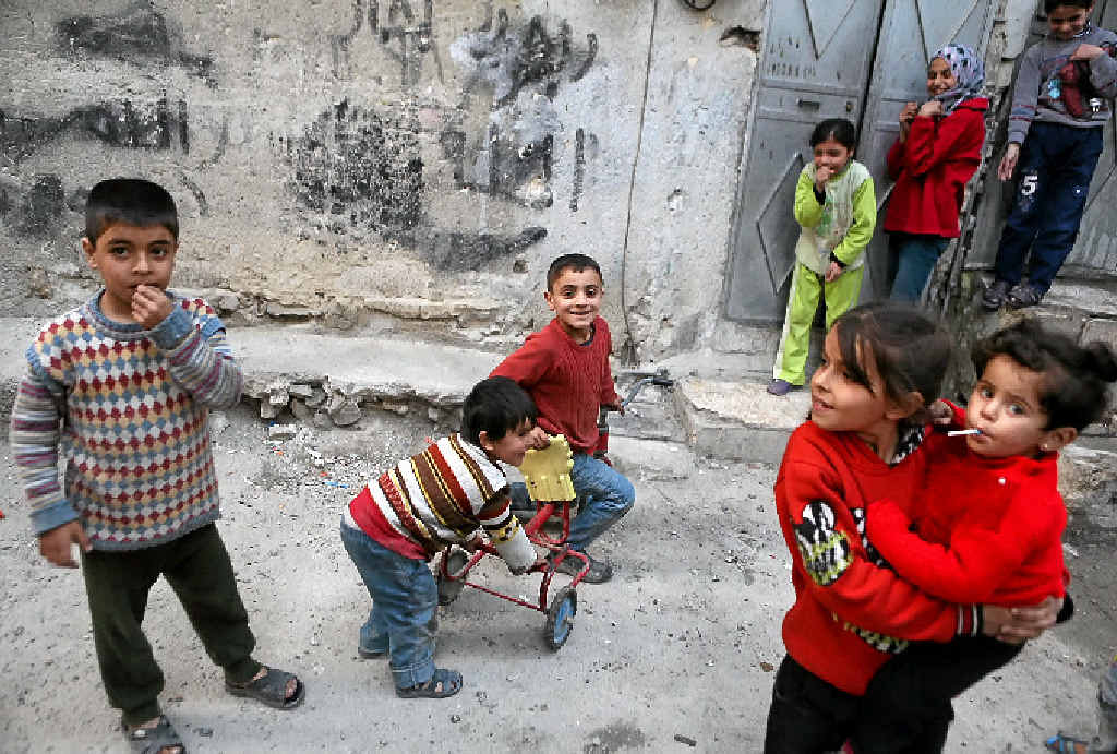 RELIEF: Syrian children play outside their home in a Damascus suburb after the ceasefire came into effect. RELIEF: Syrian children play outside their home in a Damascus suburb after the ceasefire came into effect.