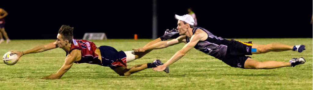 FULL STRETCH: Players display their desperation during the Super 8 finals at One Mile. FULL STRETCH: Players display their desperation during the Super 8 finals at One Mile.