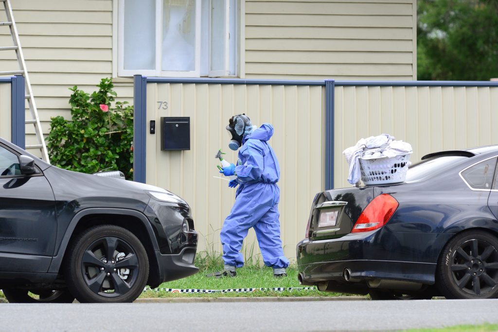 Police and forensic officers inspect a Booval property following a fatal shooting last week. Police and forensic officers inspect a Booval property following a fatal shooting last week.
