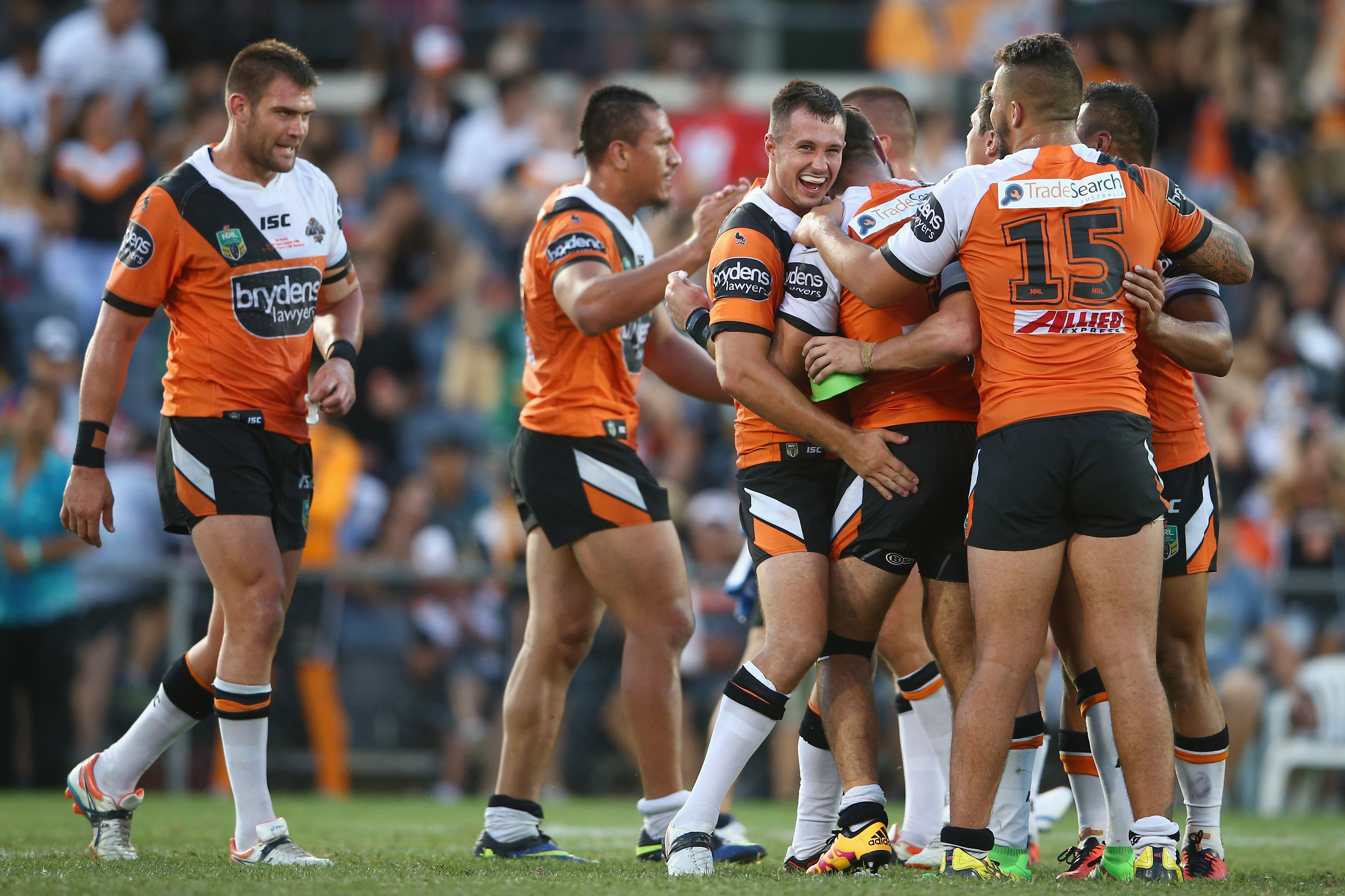 James Tedesco celebrates with Tigers teammates after the video referee gave his try the all clear. Photo: Getty Images. James Tedesco celebrates with Tigers teammates after the video referee gave his try the all clear. Photo: Getty Images.